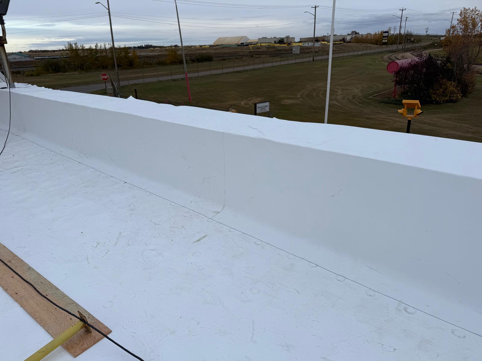 Snow diverter installation on commercial roof